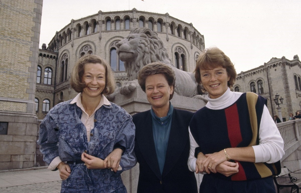 Tre kvinner står foran Stortinget.
