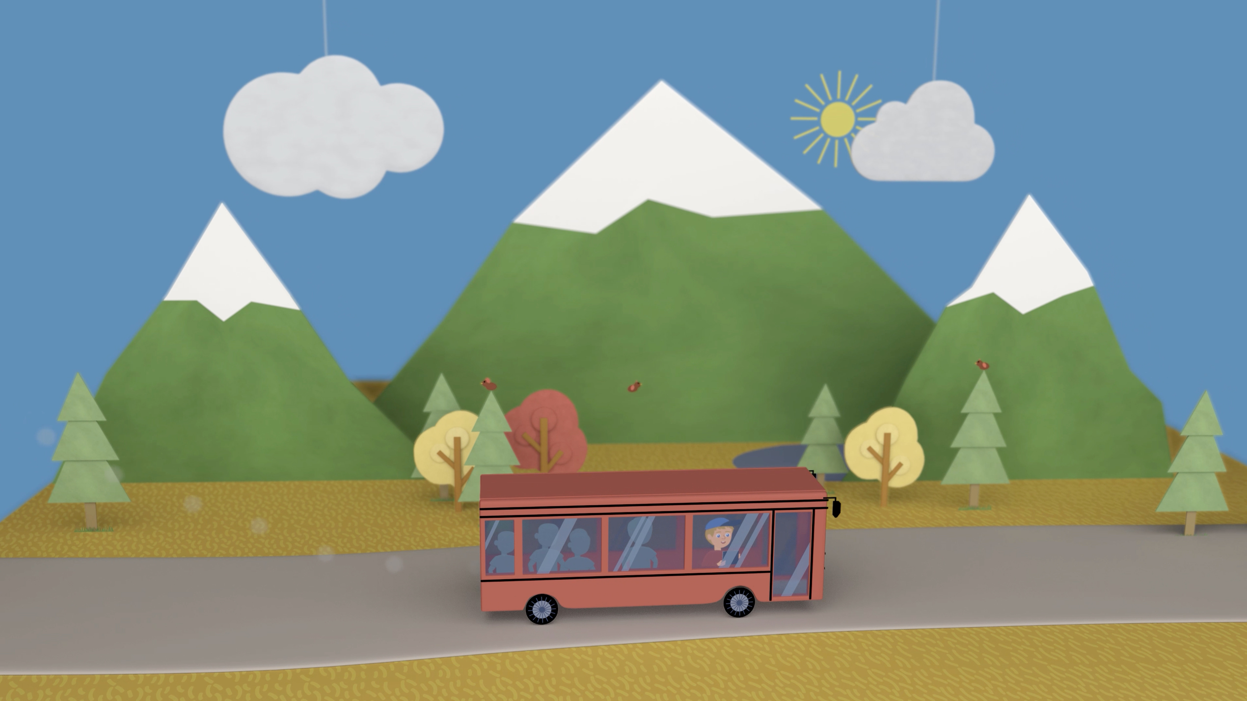 En skolebuss kjører på en vei med fjell i bakgrunnen.