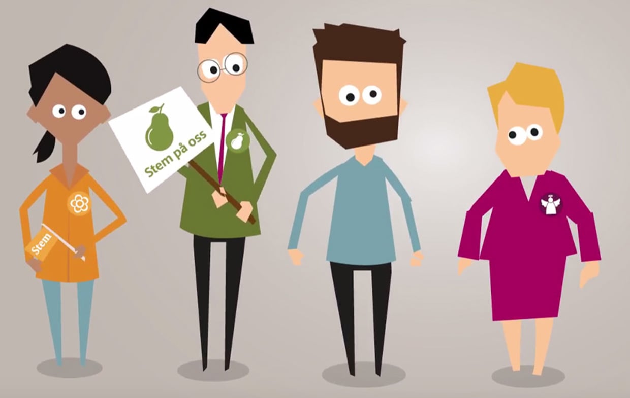 Fire personer står ved siden av hverandre. De har pins på brystet som viser partitilhørighet og en av personene holder en plakat.