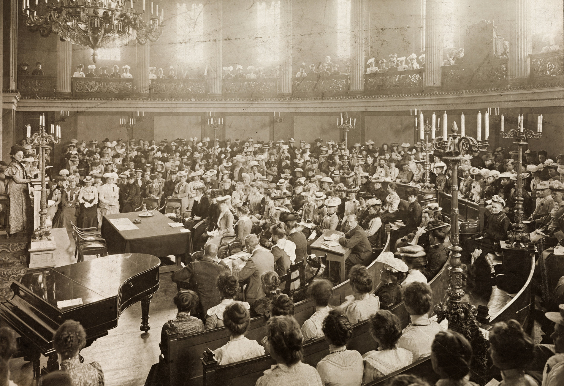 Mange kvinner sitter i en sal.