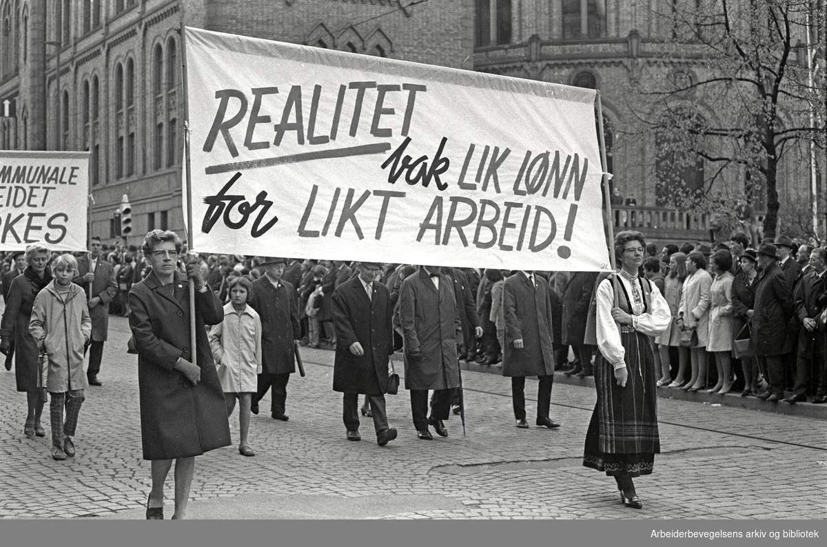 Kvinner marsjerer forbi Stortinget i 1968 under parolen "lik lønn for likt arbeid". Foto i svart hvitt.